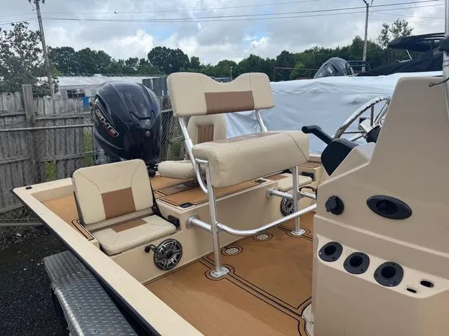 Slide: The Image of 2022 G3 BAY 22 DELUXE boat interior with seating and controls. - 6