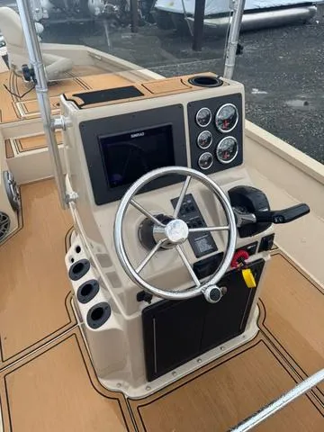 Slide: The Image of 2022 G3 BAY 22 DELUXE boat console with steering wheel and gauges. - 7