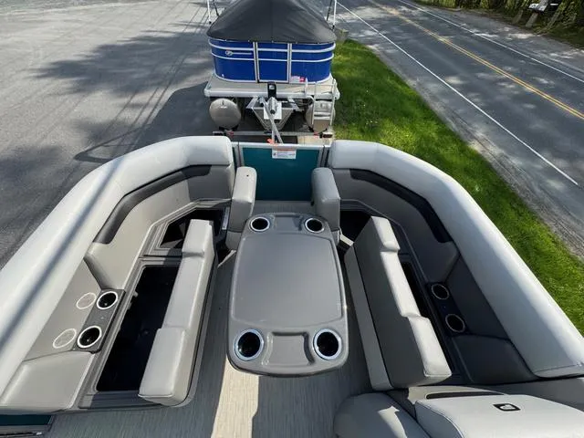 Slide: The Image of 2025 Princecraft Vectra 19 L 60HP pontoon boat interior with gray seating and storage compartments. - 11