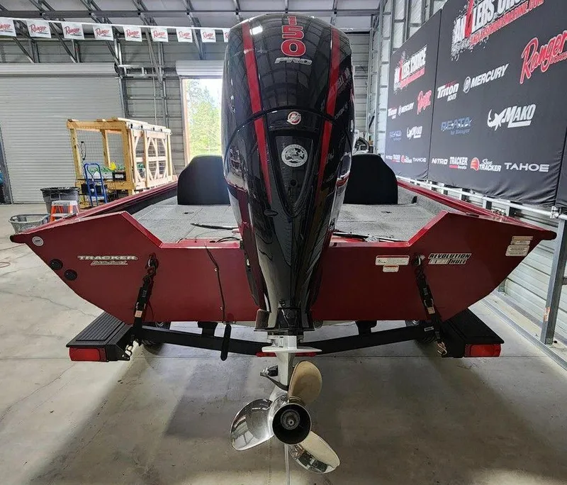 Slide: The Image of 2025 Tracker Pro Team™ 195 Tournament Edition boat in a garage, rear view. - 8