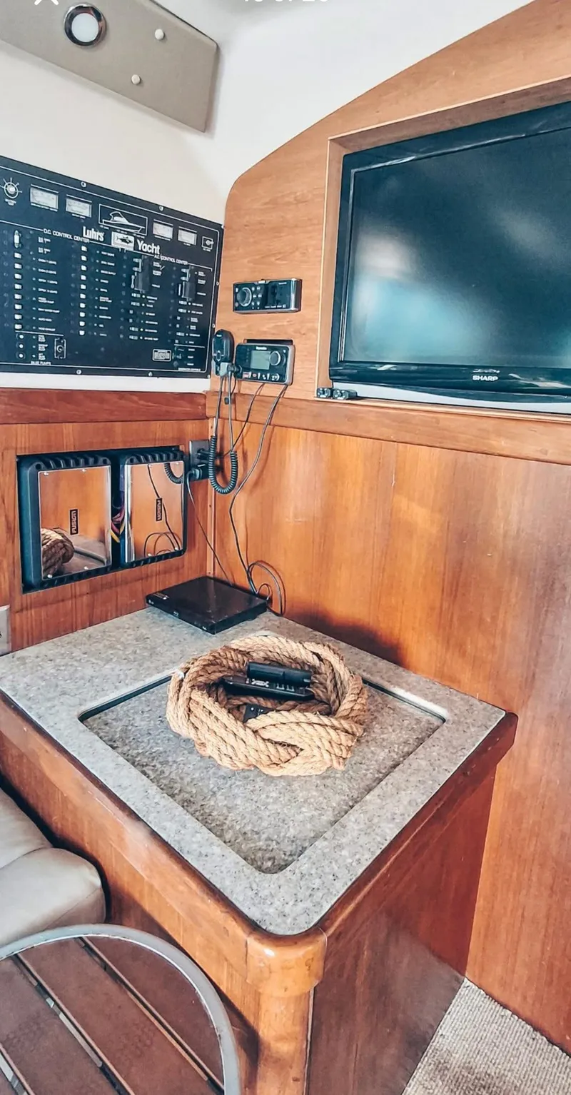 Slide: The Image of 1993 Luhrs 350 Tournament cabin interior with control panel and TV. - 13