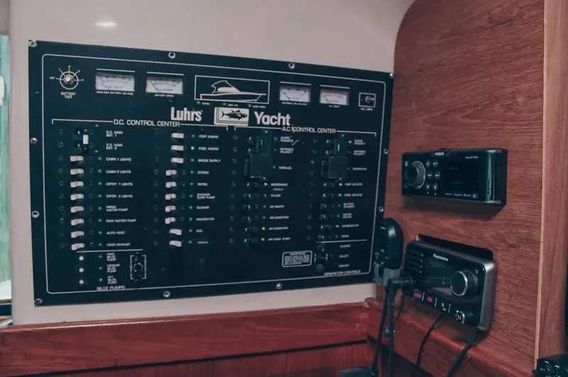 Slide: The Image of Control panel of a 1993 Luhrs 350 Tournament yacht with various switches and gauges. - 14