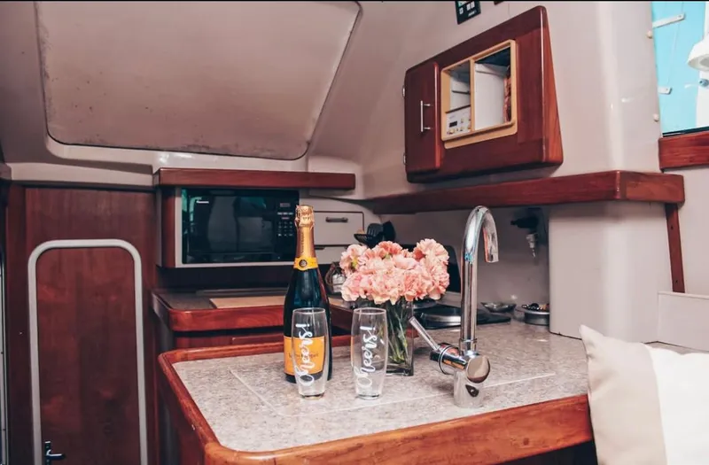 Slide: The Image of 1993 Luhrs 350 Tournament yacht interior with flowers and champagne on the counter. - 15