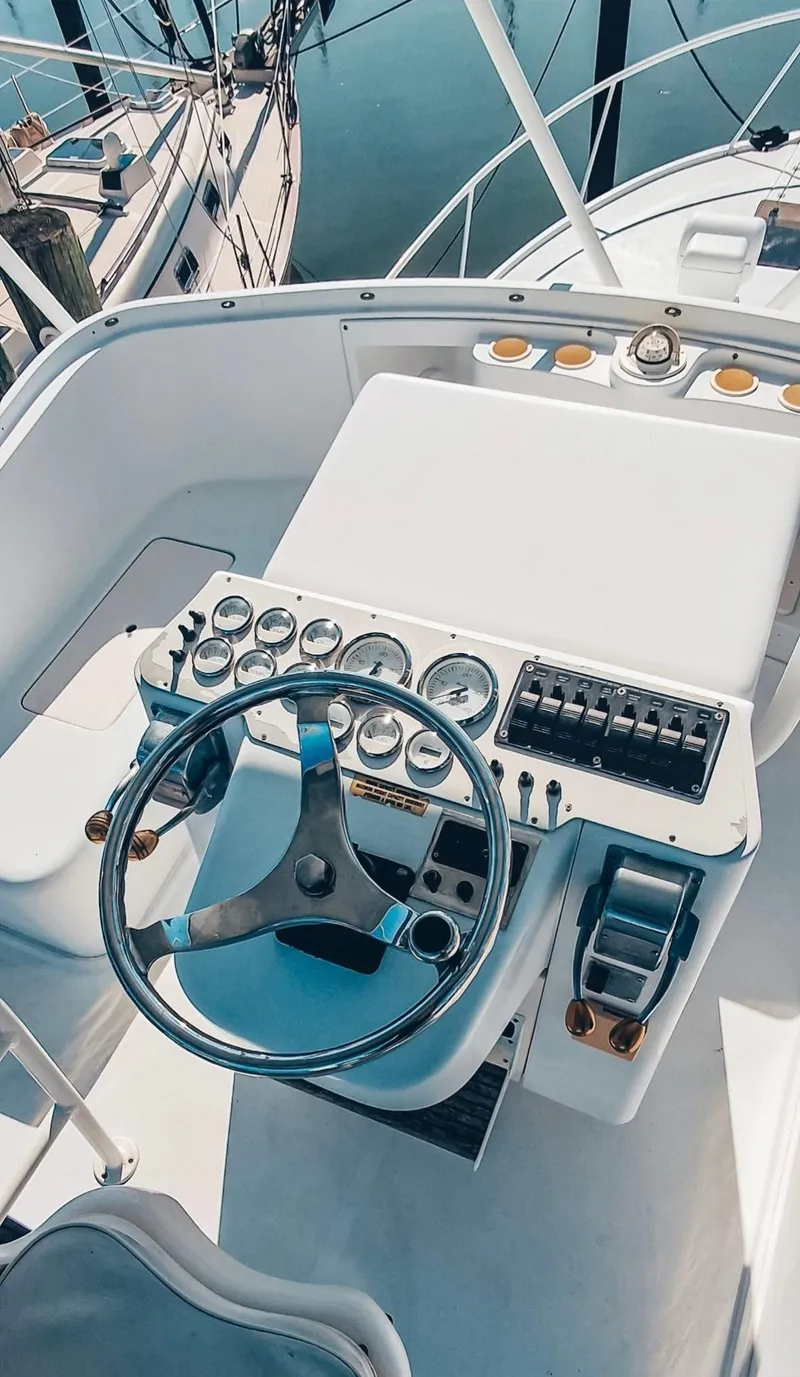 Slide: The Image of 1993 Luhrs 350 Tournament boat helm with steering wheel and control panel. - 4