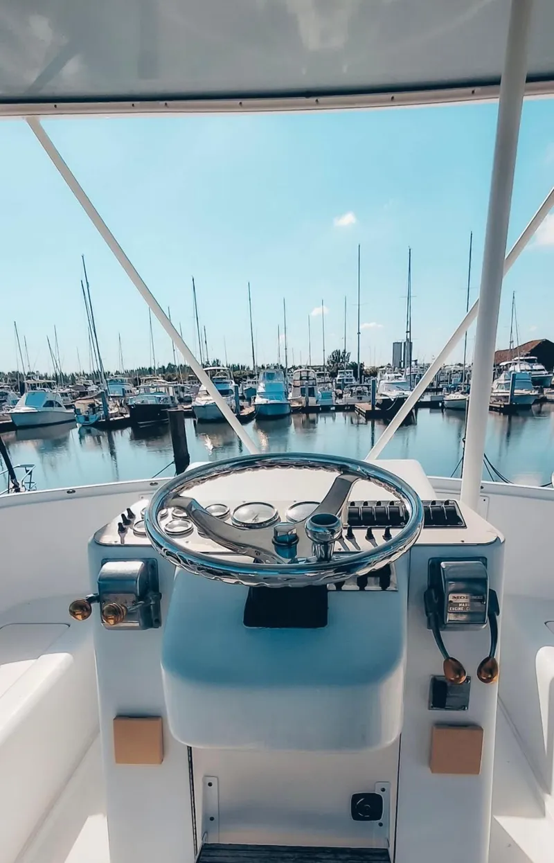 Slide: The Image of 1993 Luhrs 350 Tournament boat helm with marina view. - 6