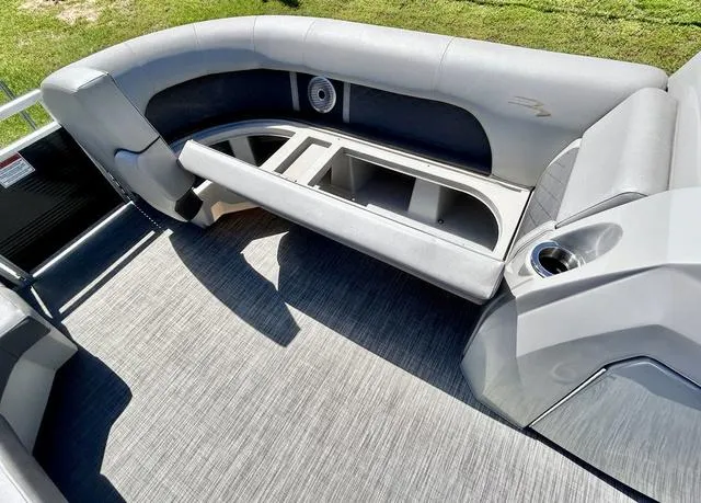 Slide: The Image of 2020 Bennington 22 SX boat interior with gray seating and storage compartments. - 11