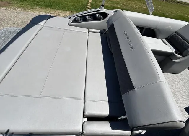 Slide: The Image of 2020 Bennington 22 SX boat interior with gray seating and cup holders. - 23