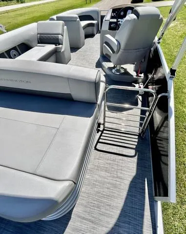 Slide: The Image of 2020 Bennington 22 SX pontoon boat interior with gray seating and helm. - 26