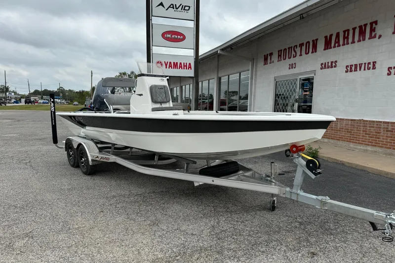 Slide: The Image of Avid 21 Mag 2025 boat on trailer at Mt. Houston Marine dealership. - 2