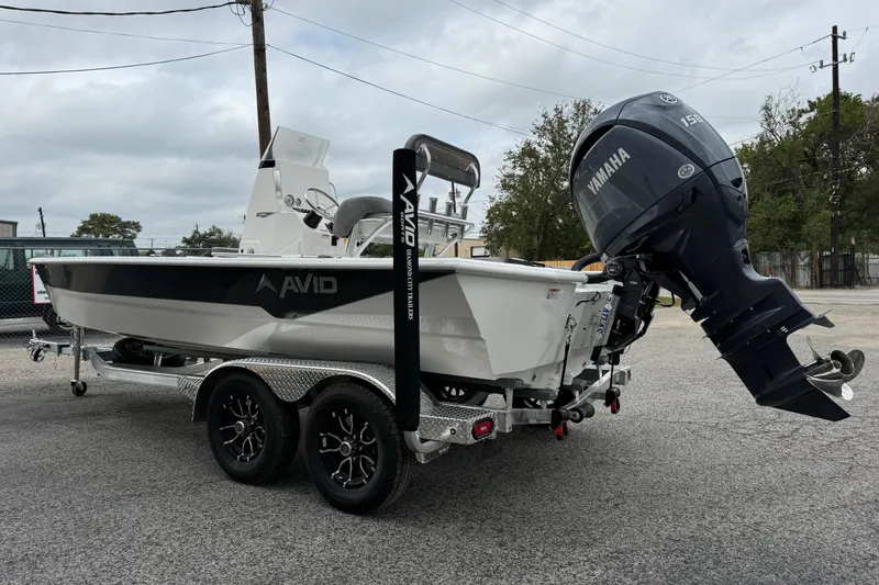 Slide: The Image of Avid 21 Mag 2025 boat with Yamaha outboard motor on a dual-axle trailer. - 4