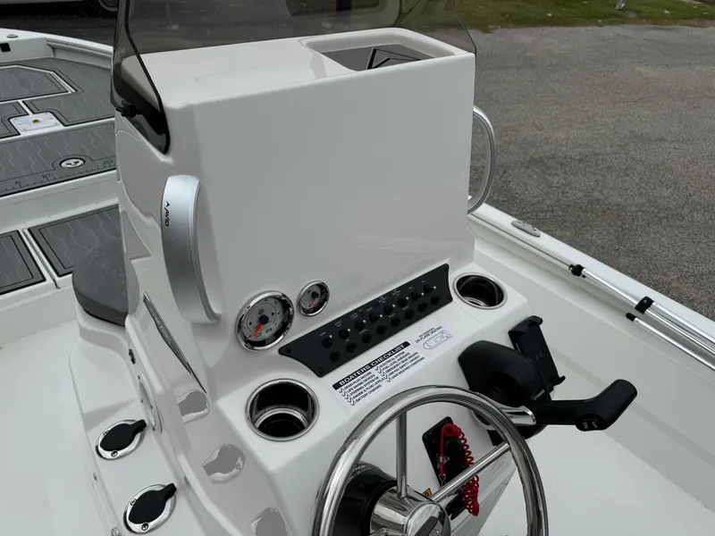 Slide: The Image of Avid 21 Mag 2025 boat console with steering wheel and control panel. - 6