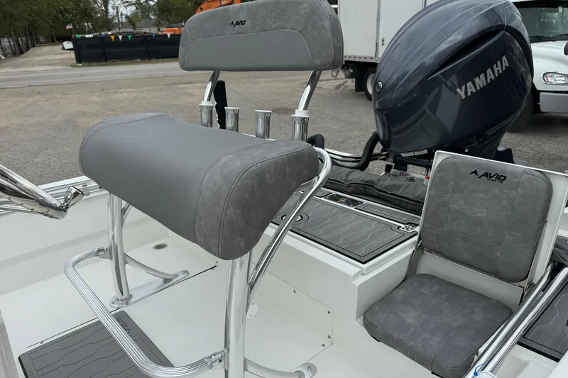 Slide: The Image of 2025 Avid 21 Mag boat interior with Yamaha engine, featuring gray seating and sleek design. - 9