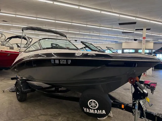 Slide: The Image of 2017 Yamaha SX195 boat displayed indoors on a trailer. - 1