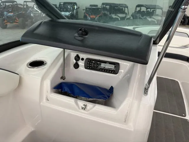 Slide: The Image of 2017 Yamaha Boats SX195 dashboard with storage compartment and audio system. - 12