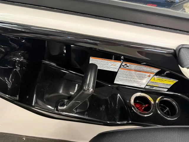 Slide: The Image of 2017 Yamaha Boats SX195 interior with control lever and cup holders. - 18