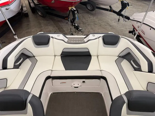 Slide: The Image of 2017 Yamaha Boats SX195 interior with white and gray seating in a showroom. - 7