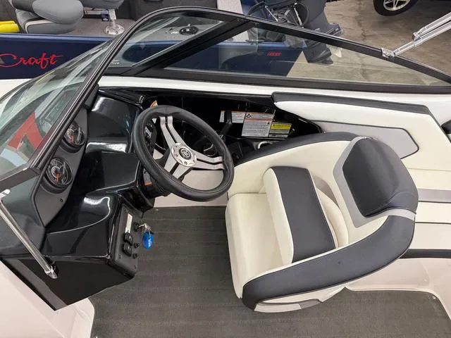 Slide: The Image of 2017 Yamaha Boats SX195 cockpit with steering wheel and seating, showcasing modern design. - 14