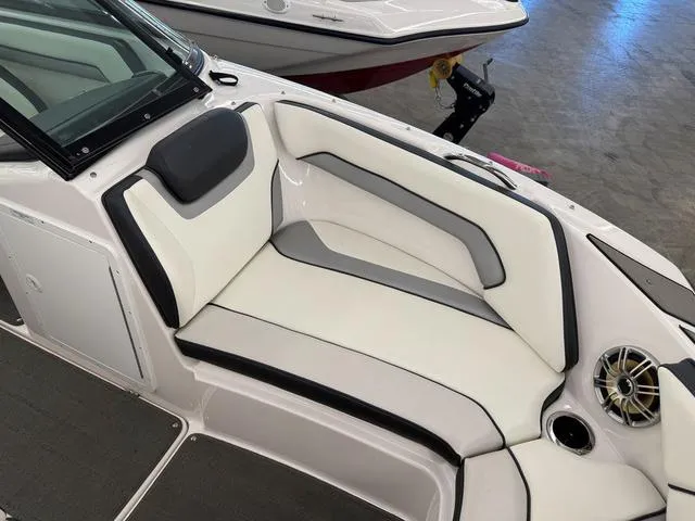 Slide: The Image of 2017 Yamaha SX195 boat interior with white and gray seating and speaker. - 20