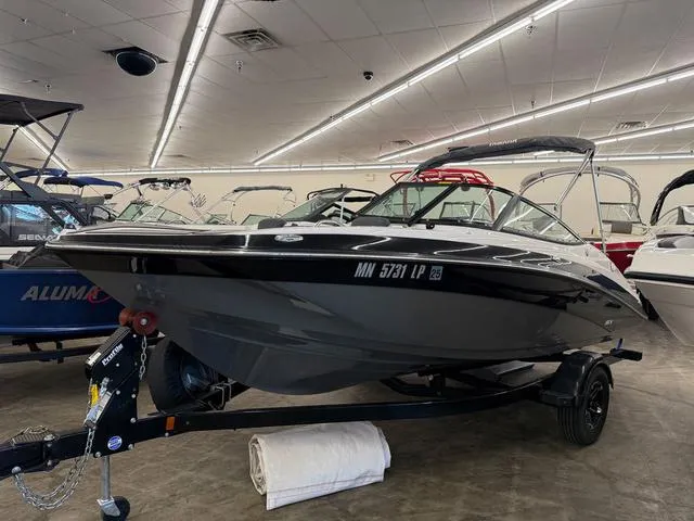 Slide: The Image of 2017 Yamaha Boats SX195 in showroom, sleek black design on trailer. - 3