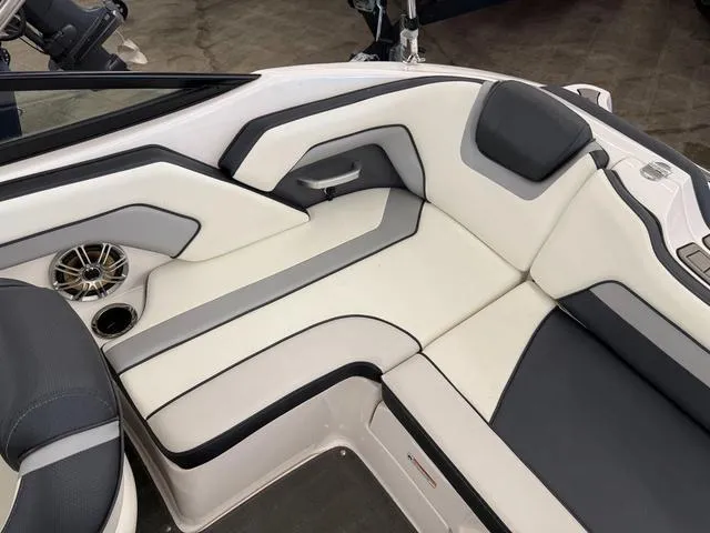 Slide: The Image of 2017 Yamaha Boats SX195 interior with white and gray seating, featuring a speaker and cup holder. - 9