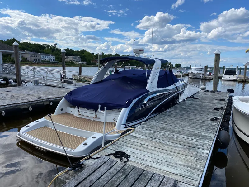 Slide: The Image of 2014 Formula 350 CBR boat docked at a marina under a partly cloudy sky. - 1