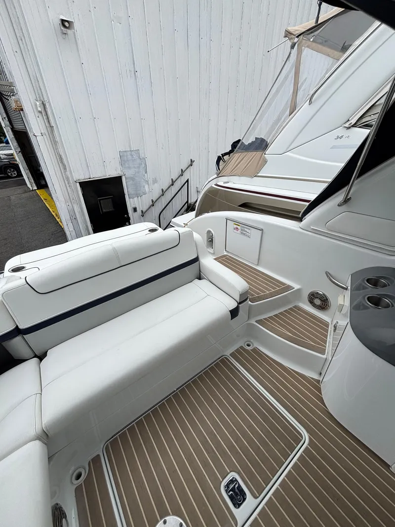 Slide: The Image of 2014 Formula 350 CBR boat interior with white seating and wood-patterned flooring. - 10