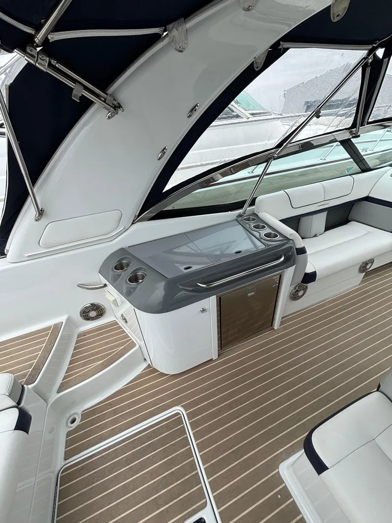 Slide: The Image of 2014 Formula 350 CBR boat interior with sleek seating and modern amenities. - 11