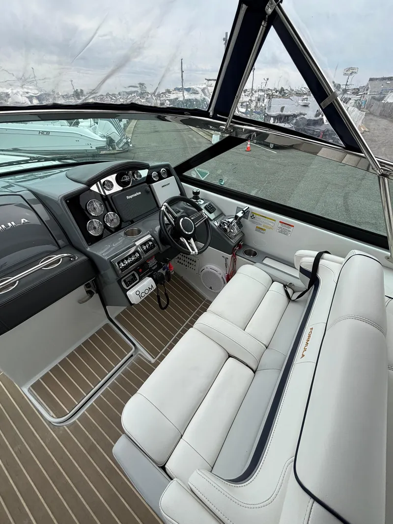 Slide: The Image of 2014 Formula 350 CBR boat interior with modern dashboard and plush seating. - 12