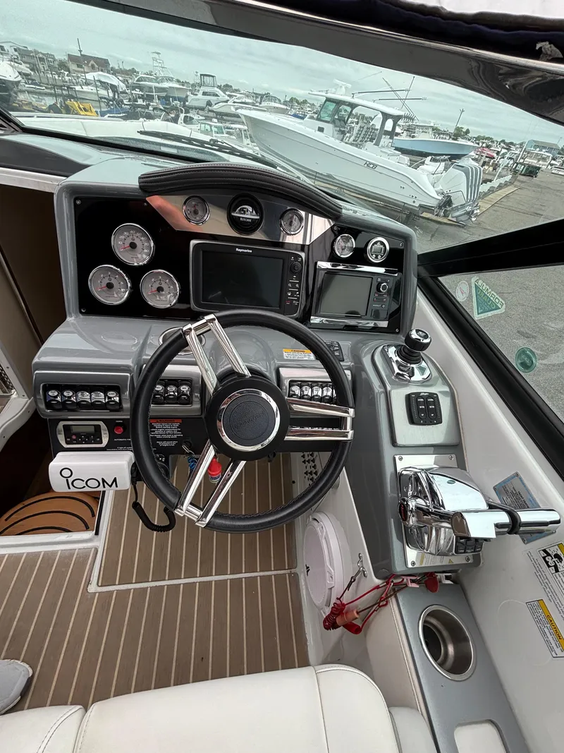 Slide: The Image of 2014 Formula 350 CBR boat cockpit with steering wheel, controls, and navigation instruments. - 13