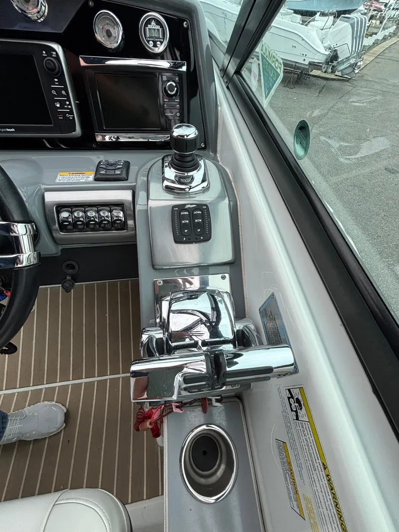 Slide: The Image of 2014 Formula 350 CBR boat cockpit with control panel and steering wheel. - 14