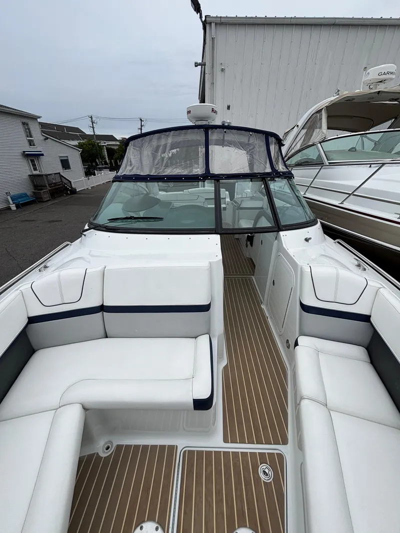 Slide: The Image of 2014 Formula 350 CBR boat with spacious seating and sleek design, docked near other vessels. - 18