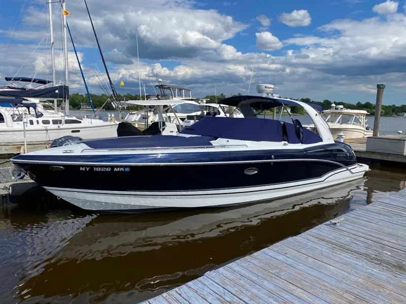 Slide: The Image of 2014 Formula 350 CBR boat docked at a marina under a partly cloudy sky. - 2