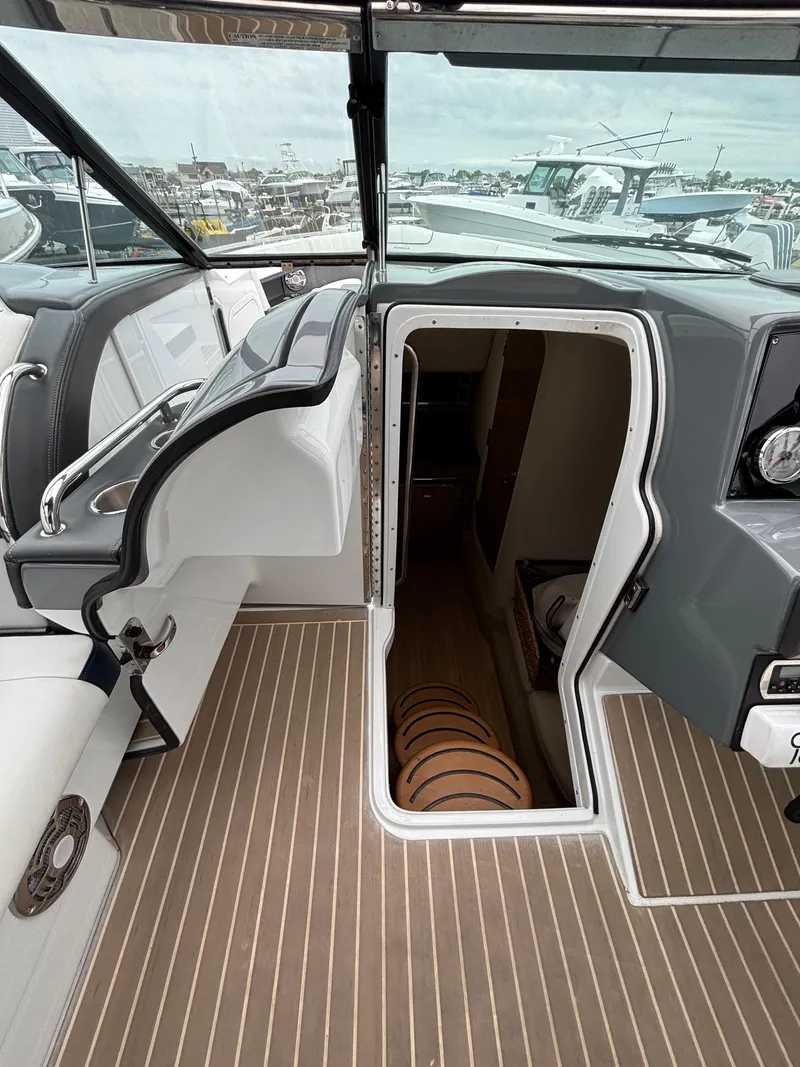 Slide: The Image of 2014 Formula 350 CBR boat interior with open cabin door, showcasing sleek design and wood flooring. - 22