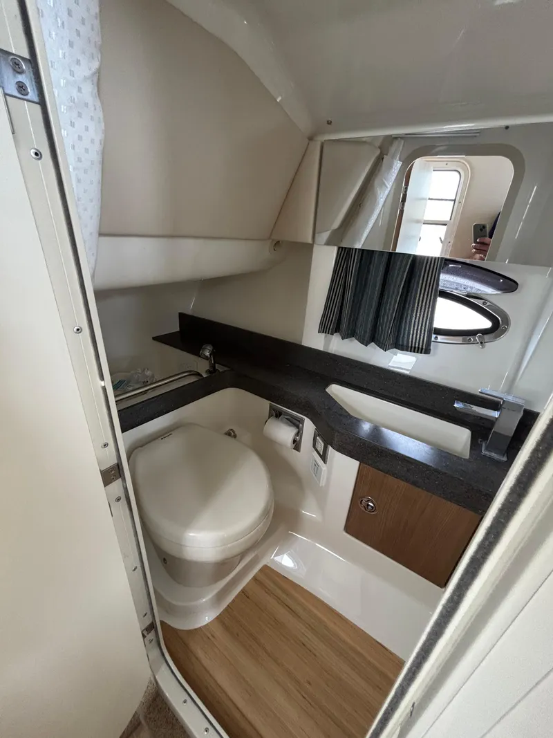 Slide: The Image of 2014 Formula 350 CBR boat bathroom with modern fixtures and wood accents. - 25
