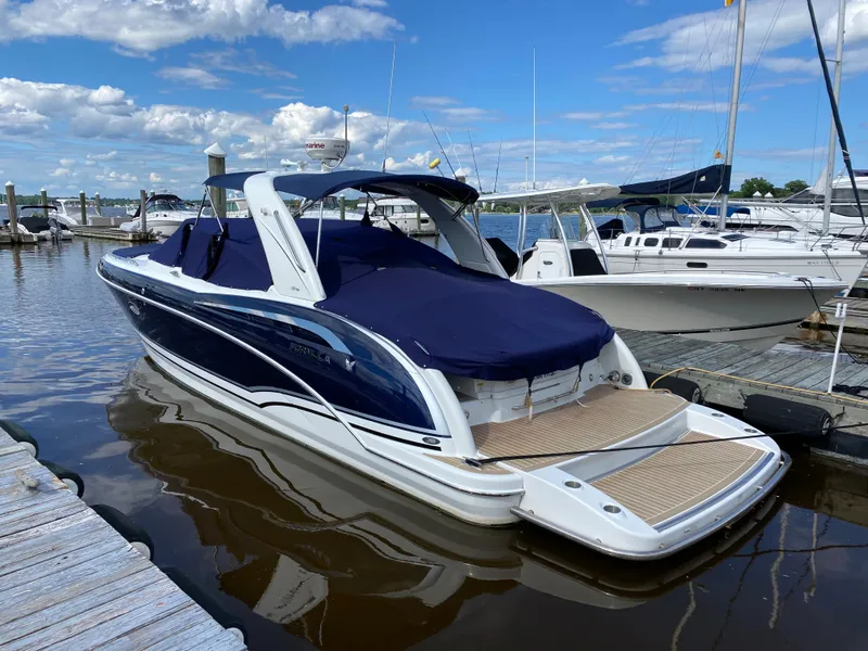 Slide: The Image of 2014 Formula 350 CBR boat docked, featuring sleek design and blue cover. - 3