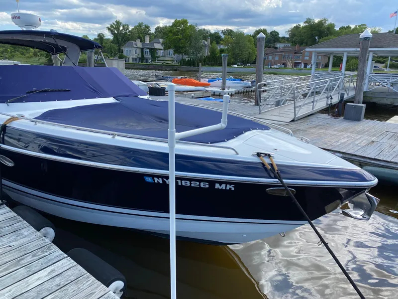 Slide: The Image of 2014 Formula 350 CBR boat docked at marina with blue cover. - 4