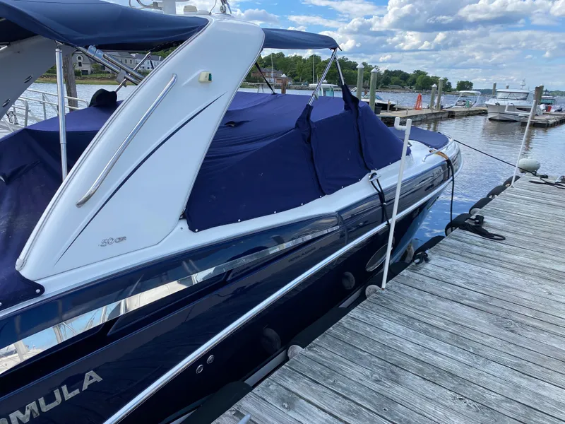 Slide: The Image of 2014 Formula 350 CBR boat docked at a marina under a blue sky. - 5
