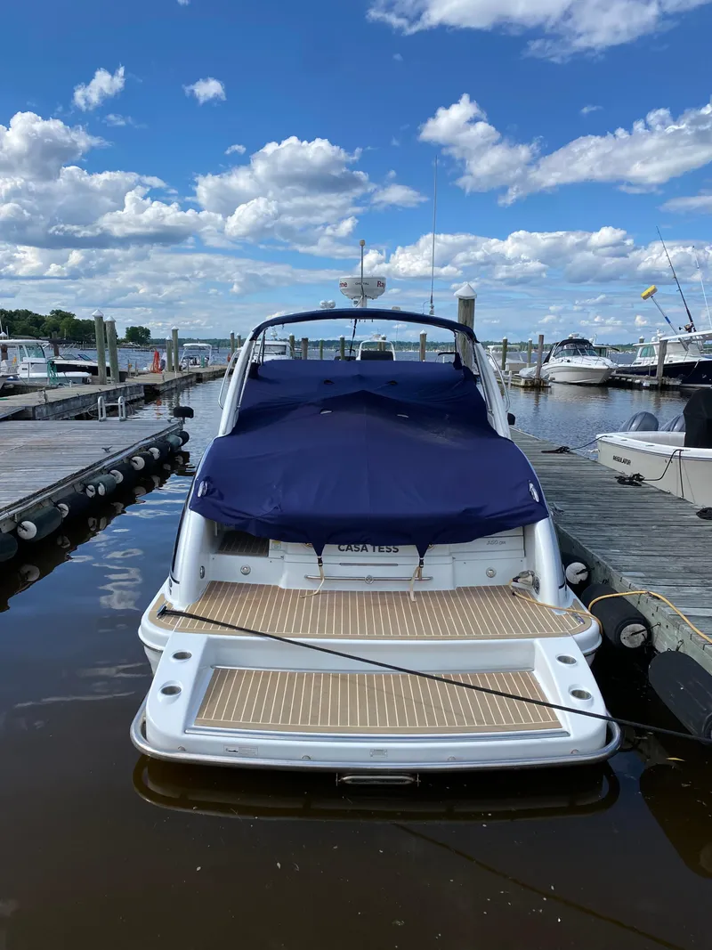 Slide: The Image of 2014 Formula 350 CBR boat docked, covered with blue tarp, under a partly cloudy sky. - 6