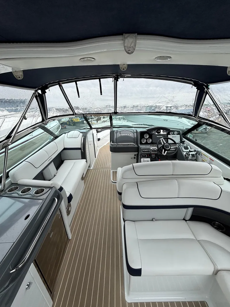 Slide: The Image of 2014 Formula 350 CBR boat interior with luxurious seating and modern dashboard. - 7