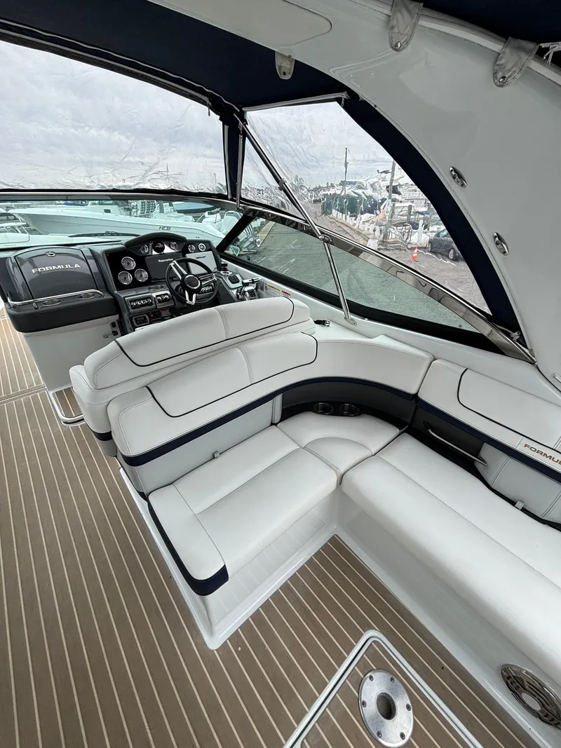 Slide: The Image of 2014 Formula 350 CBR boat interior with white seating and modern dashboard. - 8