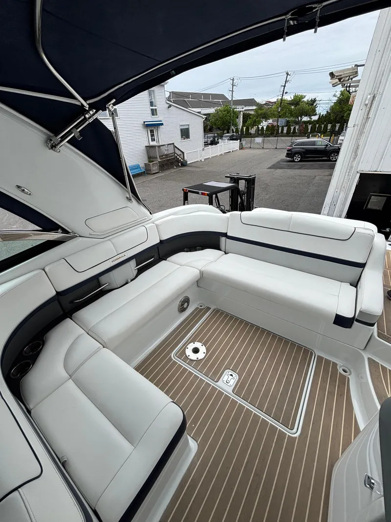 Slide: The Image of 2014 Formula 350 CBR boat with spacious white seating and teak flooring. - 9
