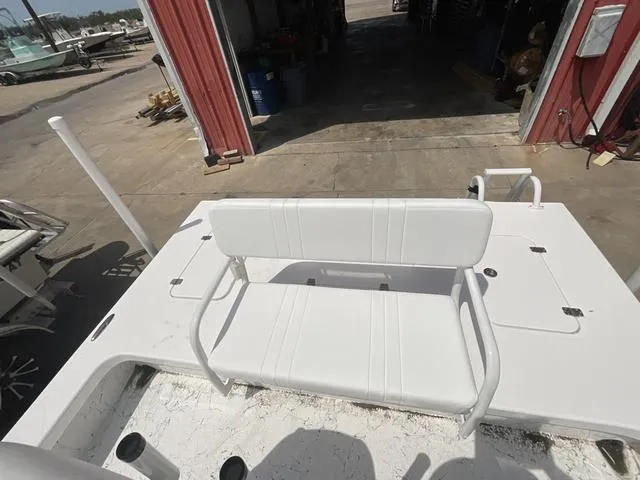 Slide: The Image of 2025 Majek 2206 Illusion boat with white seating, docked near a red building. - 14