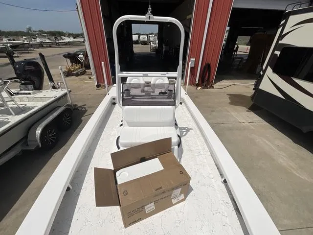 Slide: The Image of 2025 Majek 2206 Illusion boat with open box on deck, parked near red building. - 7