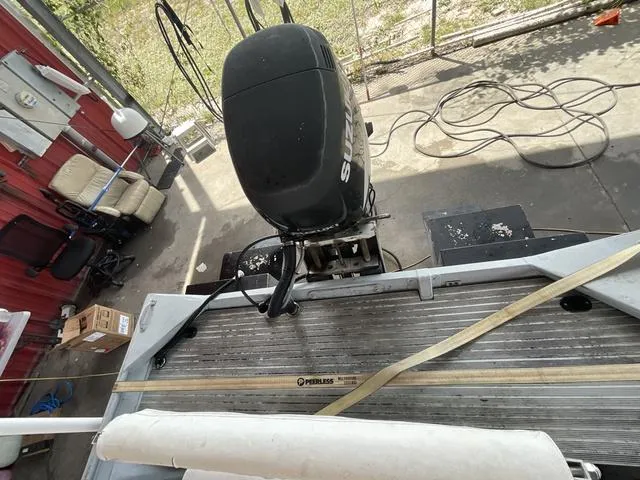 Slide: The Image of 2000 Alumacraft boat with Suzuki outboard motor in a workshop setting. - 14