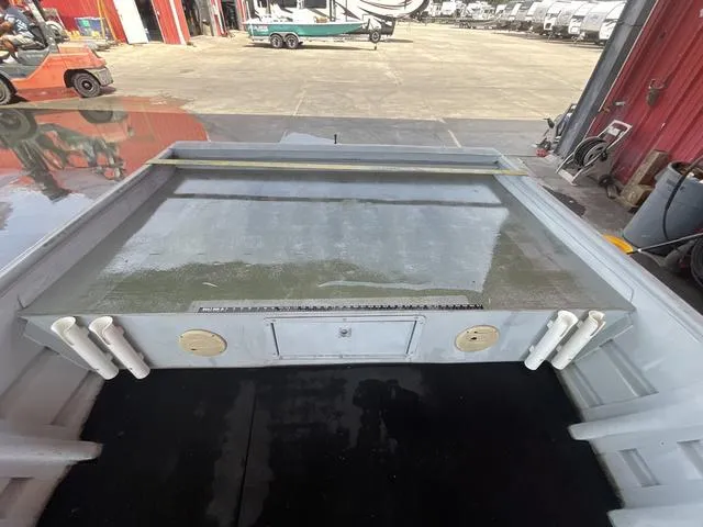 Slide: The Image of 2000 Alumacraft boat interior with rod holders and storage compartments. - 7