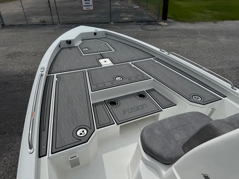 Slide: The Image of 2025 Avid 21 Fusion boat deck with gray seating and storage compartments. - 11