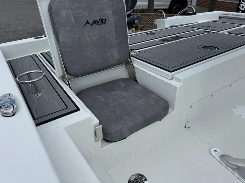 Slide: The Image of Avid 21 Fusion 2025 boat seat with gray cushion and storage compartments. - 12