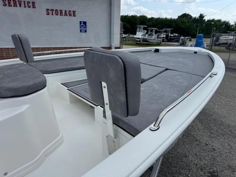 Slide: The Image of Avid 21 Fusion 2025 boat with gray seating and storage compartments. - 15