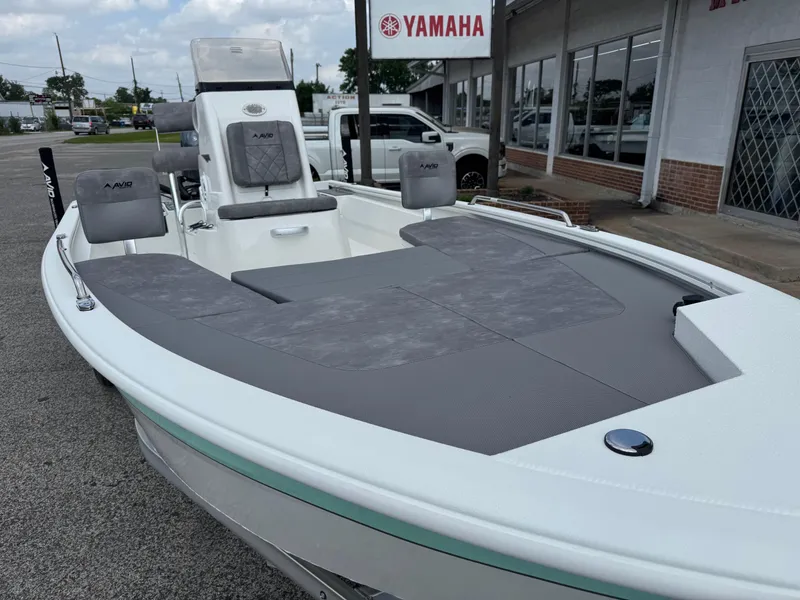 Slide: The Image of 2025 Avid 21 Fusion boat with gray seating, displayed outside a Yamaha dealership. - 4