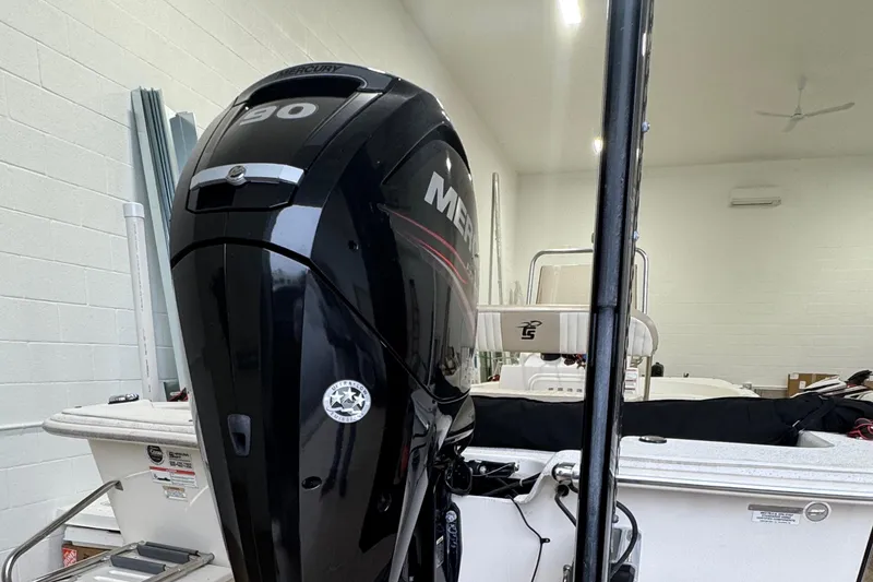 Slide: The Image of 2017 Carolina Skiff 19 LS boat with a powerful Mercury outboard motor in a garage. - 13